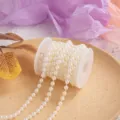 Detailed shot of white plastic pearl string on spool for DIY crafts, wedding and home decor. - Beige