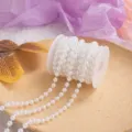White plastic pearl bead string detail view, perfect for wedding and Christmas decoration. - White