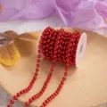 Detailed close-up of the red electroplated plastic bead chain roll, showing shiny round pearls. - Red