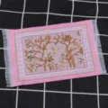 Miniature dollhouse Turkish rug with pink border and tassels, perfect for micro scene decoration. - Pink
