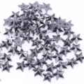 Detailed close-up shot of scattered dark metallic star-shaped beads for DIY craft accessories. - 100 Pieces/Pack / Gunmetal