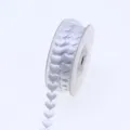 Close-up of white heart ribbon roll, satin fabric material detail for gift wrapping and decor. - 15mm / White