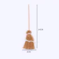 Miniature broom accessory detail shot, showing hand-woven texture and wooden handle structure. - Natural