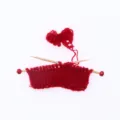 Miniature dollhouse hand-knitted red sweater with wooden needles and yarn detail view - Red