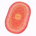 Miniature oval woven carpet detail, traditional Turkish dollhouse rug decoration. - Orange