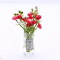 Detailed view of miniature dollhouse glass vase with artificial red flowers and blessing label. - Red