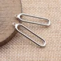 Nahaufnahme Detailansicht silberner hohler ovaler geometrischer DIY Schmuck Metall Anhänger. - Weißgold
