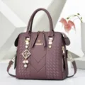 Stylish purple embossed leather handbag with chic pearl charm, perfect for daily casual wear. - Tag Charm Style / Purple