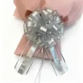 Detailed view of large silver grid pull bow decoration, perfect for gift wrapping and wedding cars. - Silver
