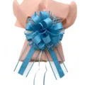 Detail shot of oversized 70# macaron blue decorative pull bow with pink gift wrapping paper. - 10 Pieces Pack / Light Blue