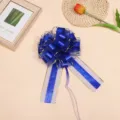 Detailed view of large blue and gold ribbon pull bow for gift wrapping and holiday decoration. - 10 Strands Pack / Blue