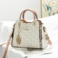 Elegant two-tone monogram tote bag with chic leaf pendant, spacious top-handle handbag. - Letter - White