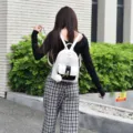 Stylish white and black women backpack, chic faux leather school bookbag with cute pendant. - S / White