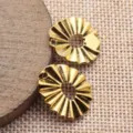 Close-up detail of gold pleated geometric oval pendant charm accessory, DIY jewelry craft. - Antique Gold