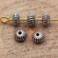 Close-up detail of antique silver ribbed spacer beads, small hole design for jewelry DIY crafting. - Antique Silver
