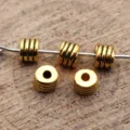 Gold metal spacer beads with threaded groove design, ideal for DIY jewelry making and crafts. - Antique Gold