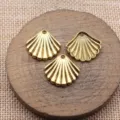 Detailaufnahme von goldenen Muschel-Anhängern im Vintage-Stil für DIY-Schmuckherstellung. - Altgold