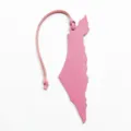 Pink leather map bag charm detail view, showing the textured finish and unique shape keychain. - Pink