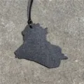 Iraqi map shaped leather bag charm detail, stylish black strap, textured surface finish. - Black
