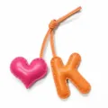 Handmade leather K letter and pink heart bag charm detail shot with contrast stitching. - Letter K (5326972886591) / Orange with Rose Red Heart