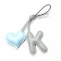Close-up detail of handcrafted leather bag charm featuring blue heart and grey letter K pendants. - Letter K (5326972886594) / Grey with Light Blue Heart