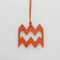 Detailed close-up of the orange leather Aquarius zodiac charm with unique geometric design. - Orange