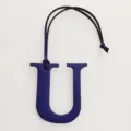 Detailed view of the blue leather letter U bag charm with hanging strap, elegant initial accessory. - Sapphire Blue