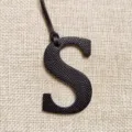 Black leather letter S bag charm, stylish hollow initial pendant for handbags and car keys. - Black