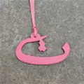 Pink leather Arabic letter bag charm detail view, stylish accessory for purses and car decor. - Pink