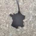 Stylish black leather France map shape bag pendant and car hanging ornament detail view. - Black