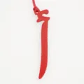 Red leather Arabic letter bag charm, elegant keychain accessory for women handbag detail view. - Red