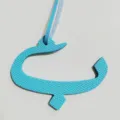 Detailed view of the blue leather Arabic letter bag charm, elegant accessory for women's bags. - Sky Blue