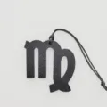 Black Virgo zodiac bag charm detail shot showing premium leather texture and hanging cord. - Black