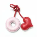 Leather bag charm featuring pink donut and red heart shapes with hand stitching details. - Light Pink with Bright Red Heart