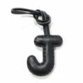 Black leather letter J bag charm close-up detail showcasing fine stitching and knot design. - Black