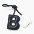 Detalle de dije de bolso de cuero letra B y corazón hecho a mano con costuras finas y dos tonos. - Negro con Corazón Crema