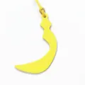 Yellow leather bag charm featuring a crescent Arabic letter design with a thin strap. - Yellow