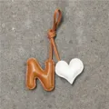 Handmade leather N letter heart bag charm pendant for women daily use accessory chic style detail view - Letter N / Light Brown with Off-white Heart