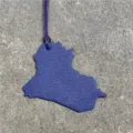 Close-up detail view of the purple leather Iraq map country shape bag charm pendant. - Blue