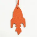 Dettaglio ciondolo borsa a razzo in pelle arancione, elegante accessorio borsa e ciondolo auto. - Arancione