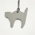 Detailed view of grey leather cat bag charm, textured leather pendant for women handbag accessory - Gray
