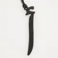 Black leather Arabic letter bag charm detail close-up, premium texture key ring pendant. - Black