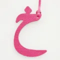 Close-up detail of the hot pink leather Arabic letter bag charm, showing fine texture and loop. - Rose Red