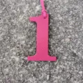 Detailed view of a hot pink leather number 1 bag charm, perfect for personalized DIY accessories. - Rose Red
