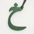 Close-up detail of dark green leather Arabic letter bag charm, premium texture and fine strap. - Dark Green