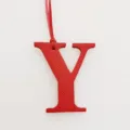 Red leather letter Y bag charm initial pendant detail view showing texture and strap. - Red