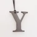 Detail view of the leather letter Y bag charm, featuring textured initial pendant with strap. - Gray