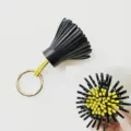 Two-tone leather tassel keychain and bag charm, stylish black and yellow sheepskin accessory. - Black/Yellow