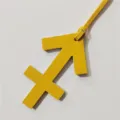 Yellow leather Sagittarius zodiac sign bag charm pendant detail, stylish astrology accessory. - Yellow