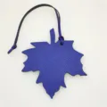 Blue leather maple leaf bag charm detail view, chic purse pendant or car hanging decoration. - Sapphire Blue